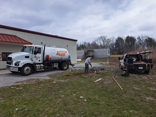 A large white truck is parked in front of a building.