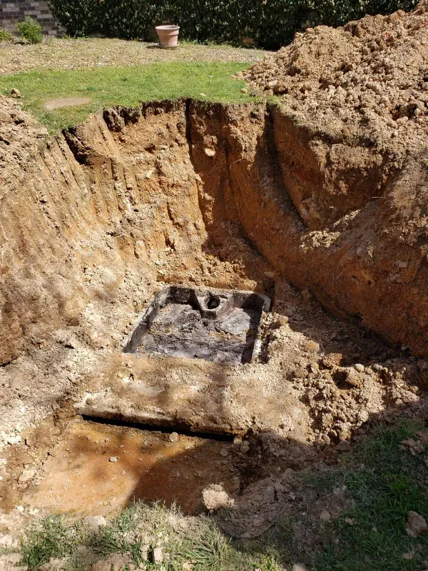 A hole in the ground with a box in it.