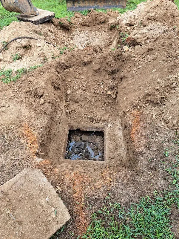 A manhole cover is being installed in a hole in the ground.