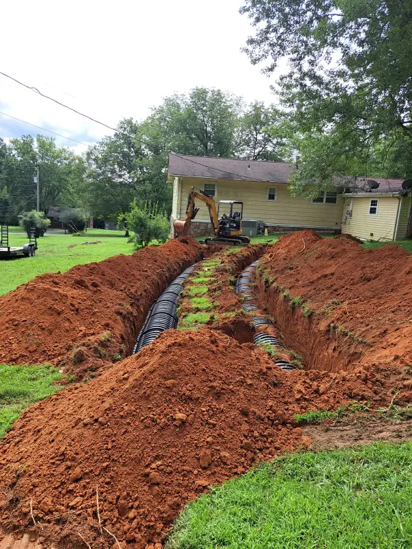 A large pile of dirt is sitting in front of a house.