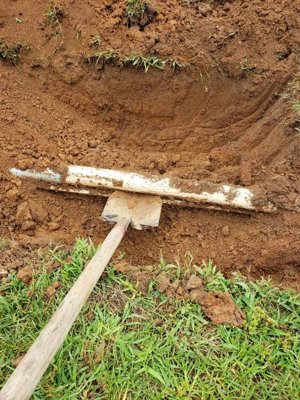 A shovel is sitting on top of a pile of dirt.