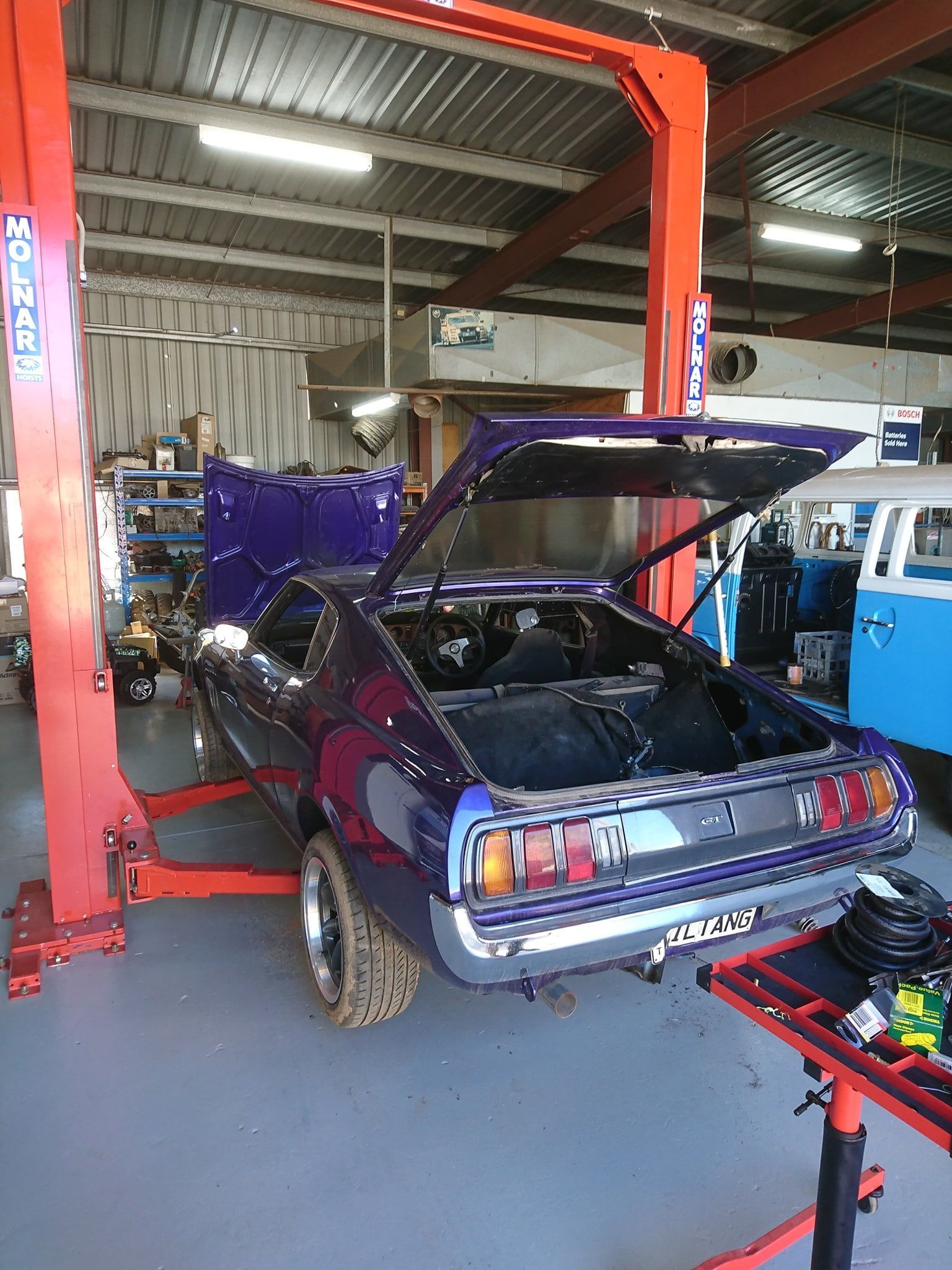 A purple car is sitting on a lift in a garage — KC Auto Electrics In Ciccone, NT