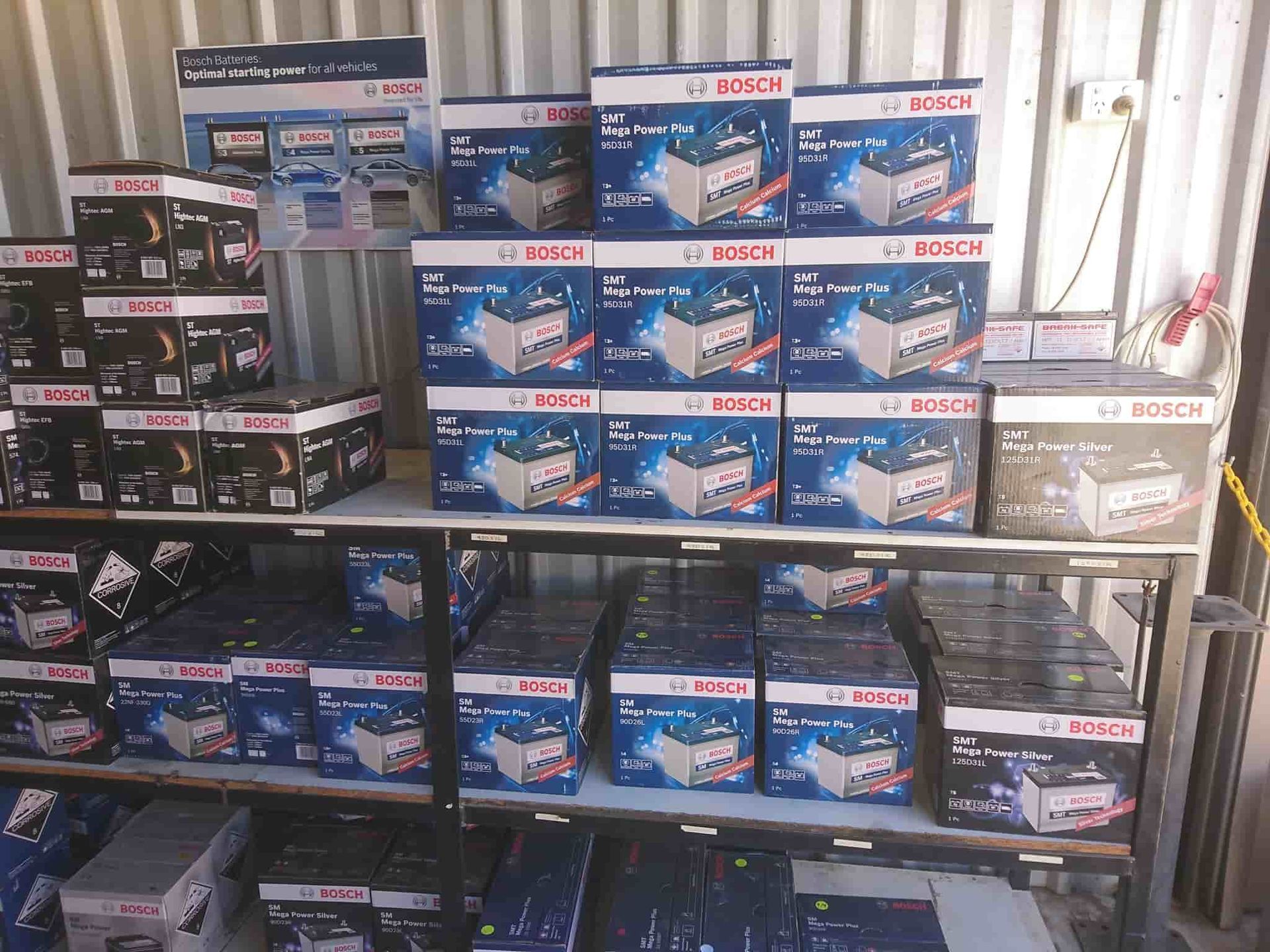 A Shelf Filled With Boxes Of Bosch Batteries — KC Auto Electrics In Ciccone, NT
