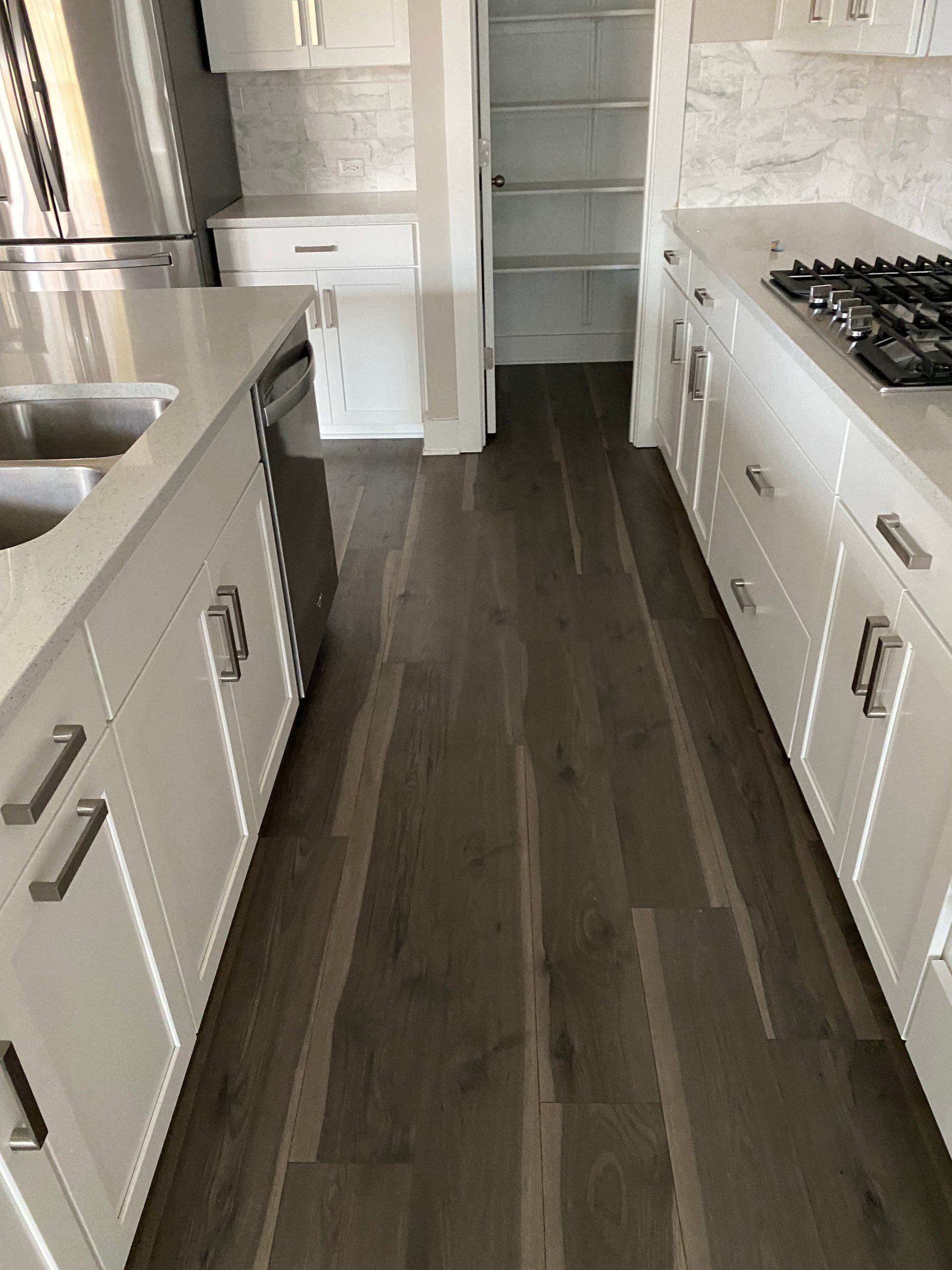 A close up of a tiled floor with black and white rocks.