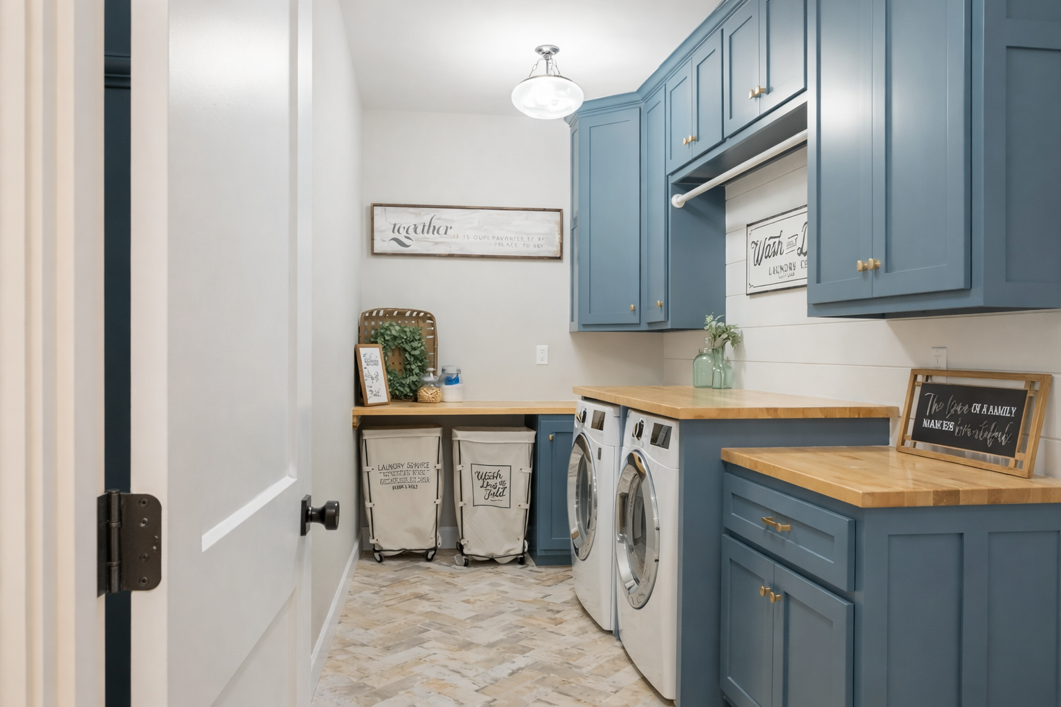 Blue Laundry Room with Stacked Washer/dryer, Sink, and Cabinets — Paul Tagget Kitchens In Goonellabah, NSW