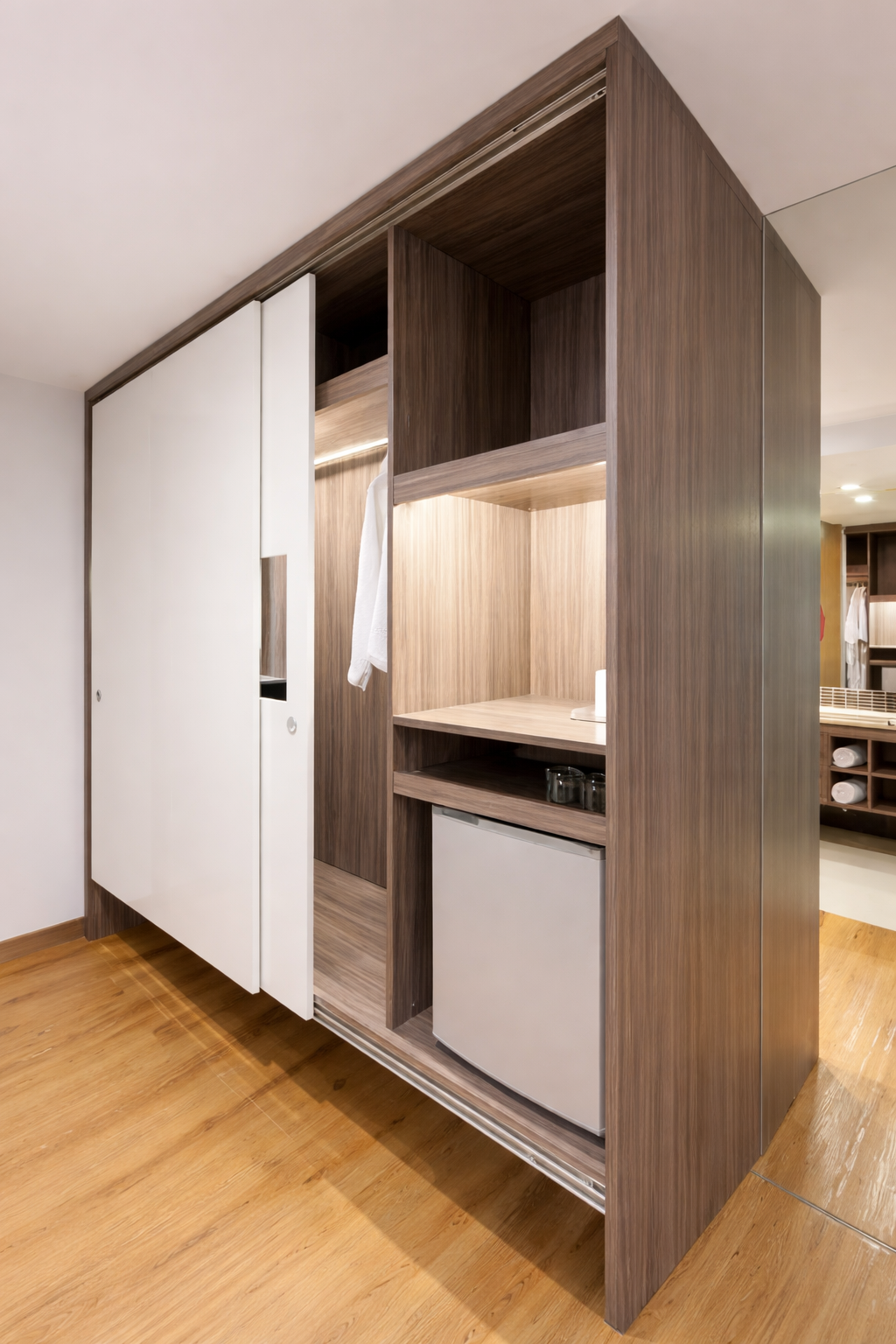 White Sliding Closet Doors in A Bedroom with Natural Light and A Rug on Wooden Floors — Paul Tagget Kitchens In Goonellabah, NSW
