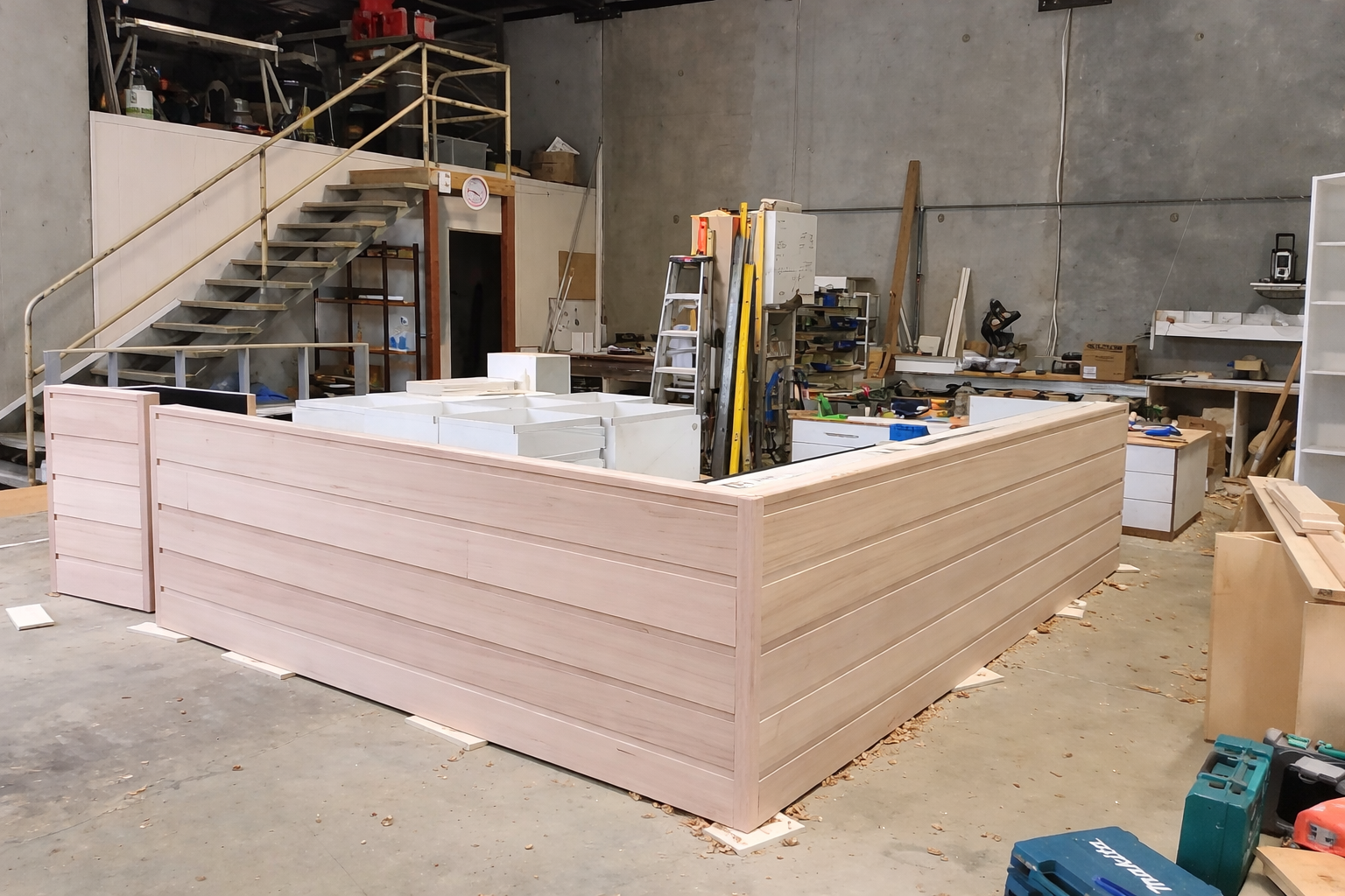 Cafe interior with display case, menu boards, and lime green wall