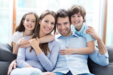 Family sitting on Couch — family counseling in Endicott,, NY