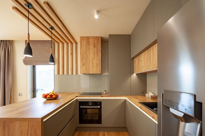 A kitchen with stainless steel appliances and wooden cabinets.