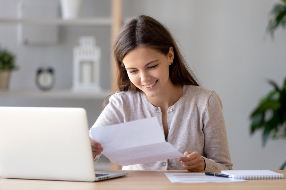 Woman Reading On Paper — Finance Services In Mornington, VIC