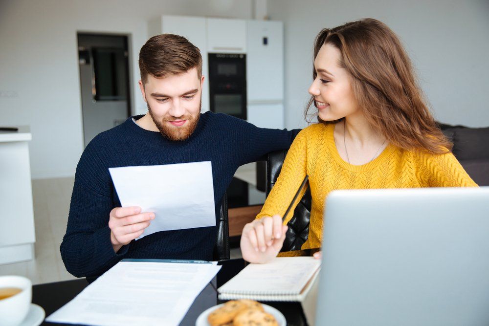 Man And Woman Looking At Papers — Finance Services In Mornington, VIC