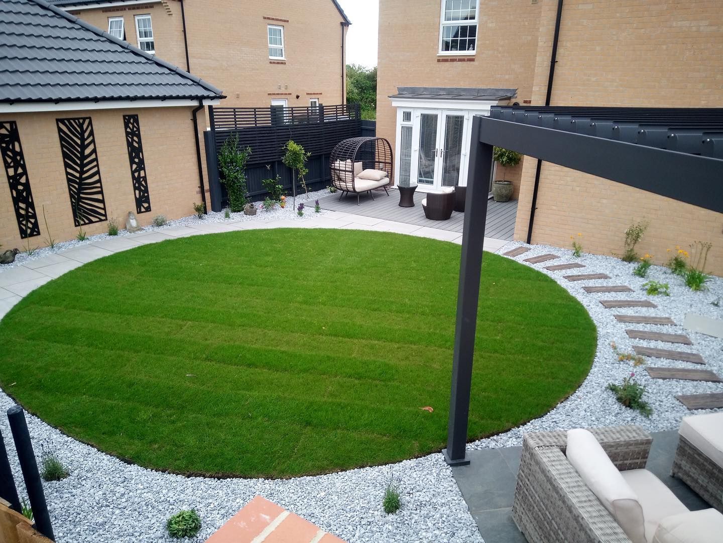 there is a circular lawn in the middle of the backyard .