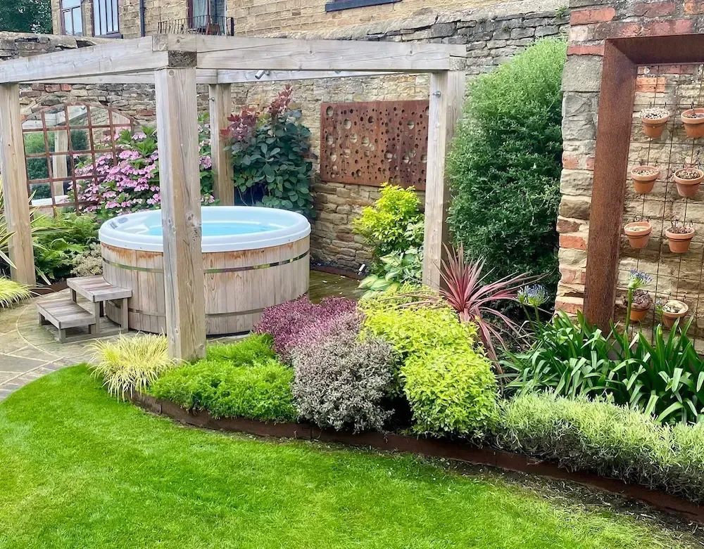 There is a hot tub in the middle of the garden.