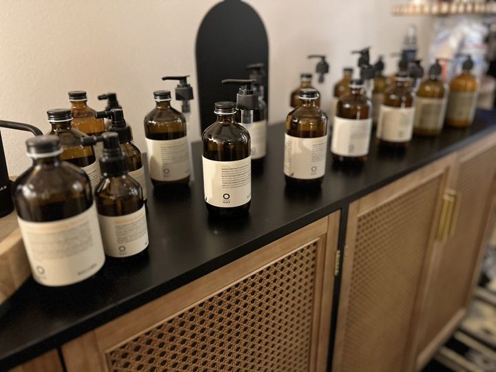 A row of bottles sitting on top of a counter — St. Charles, IL — Studio Genesis - Hair Loss Solutions