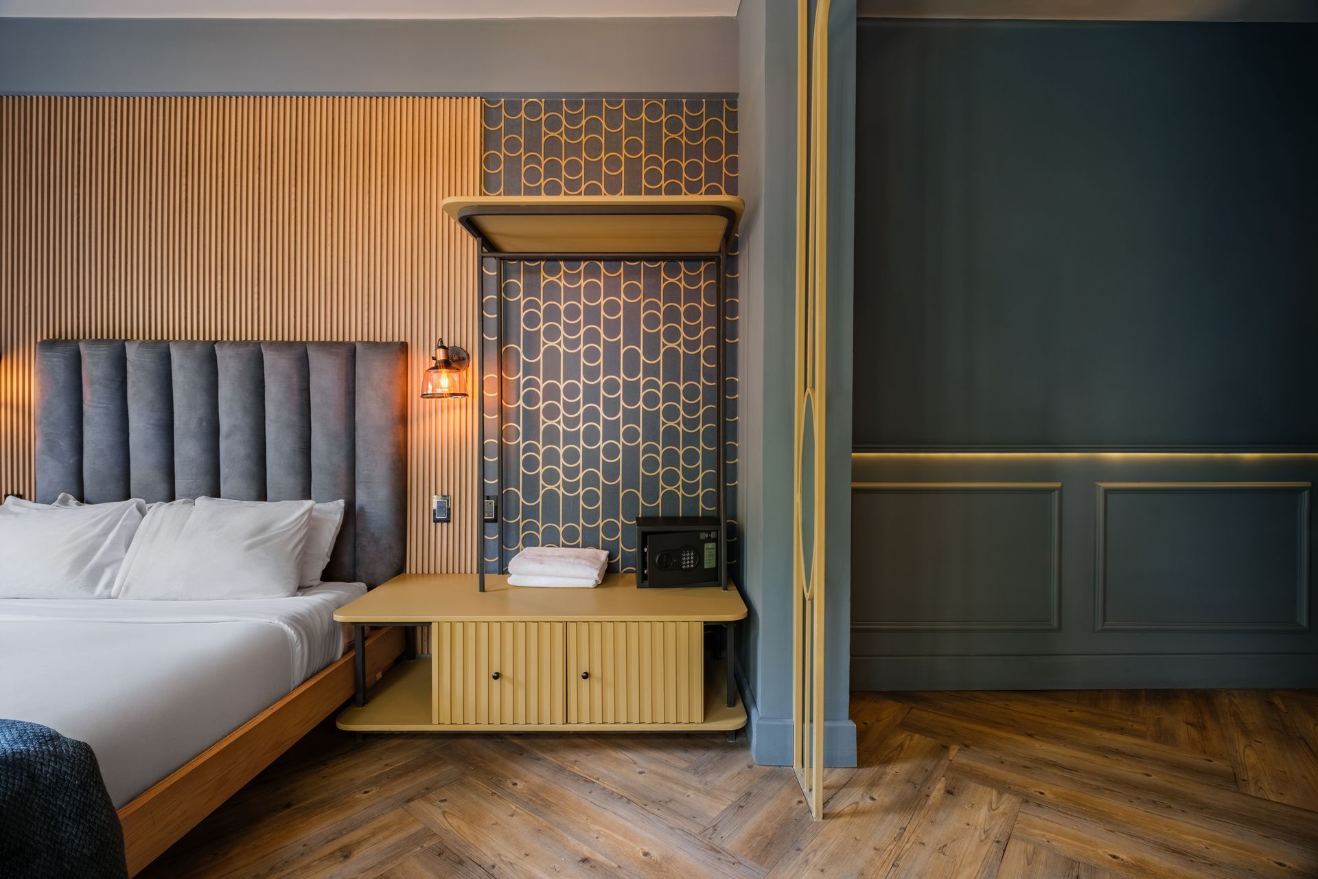 A hotel room with a king size bed , table and chairs.