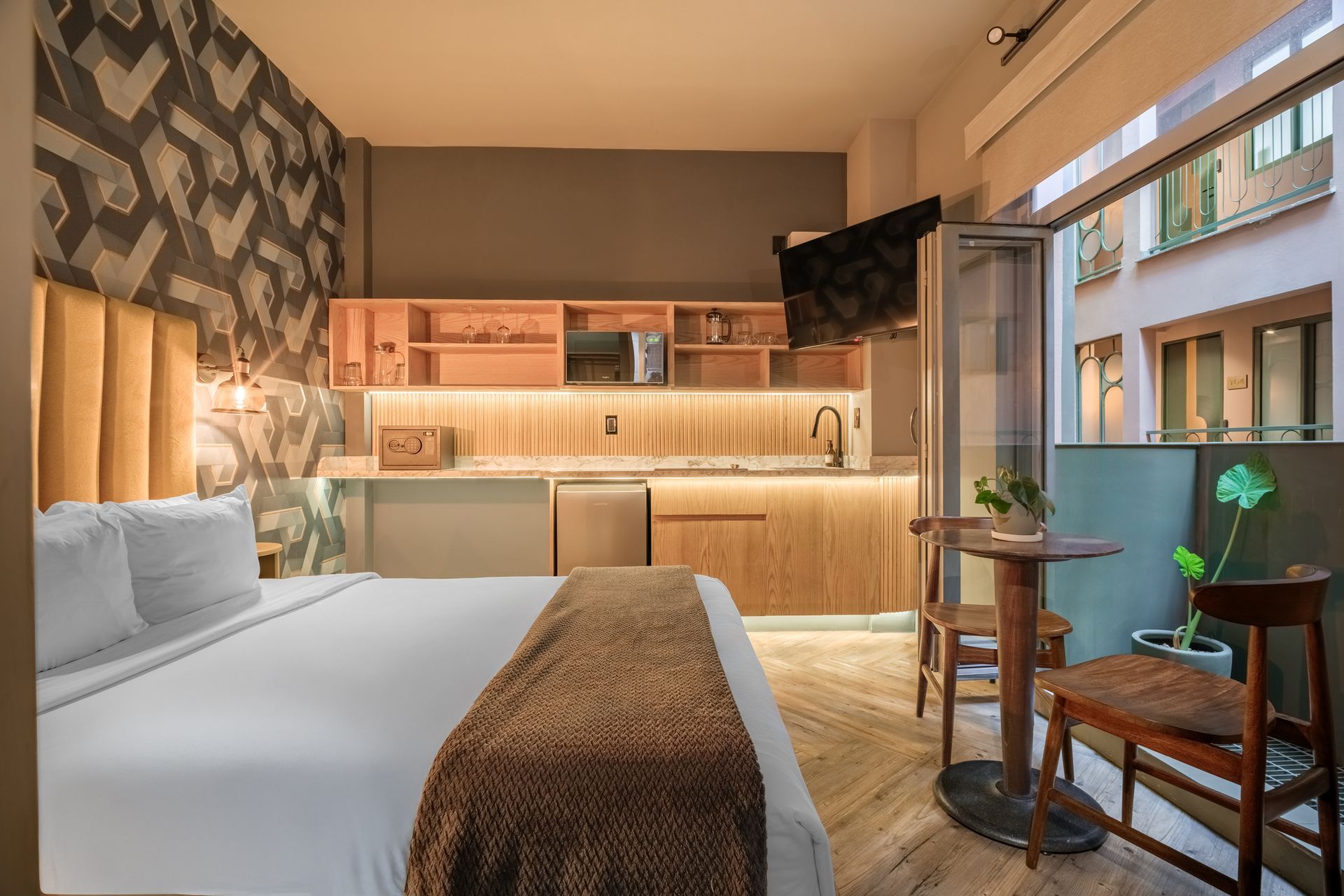 A bedroom with a large bed and a large window.