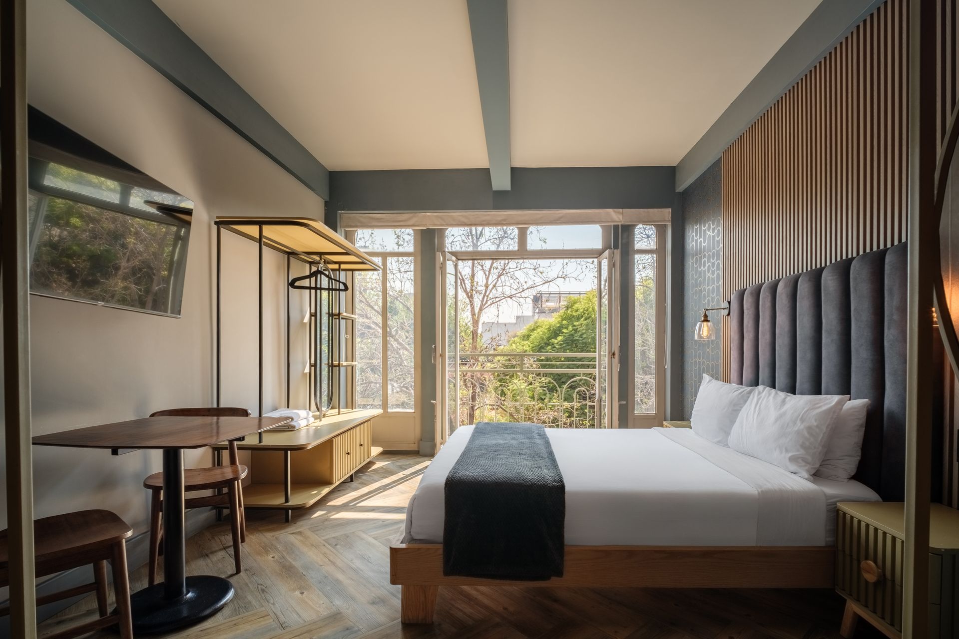 A hotel room with a king size bed and a kitchen.