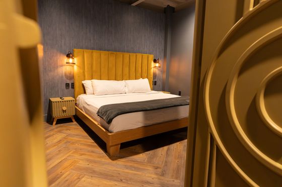 A bedroom with a king size bed and two nightstands.