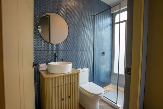 A bathroom with a sink , toilet and shower.