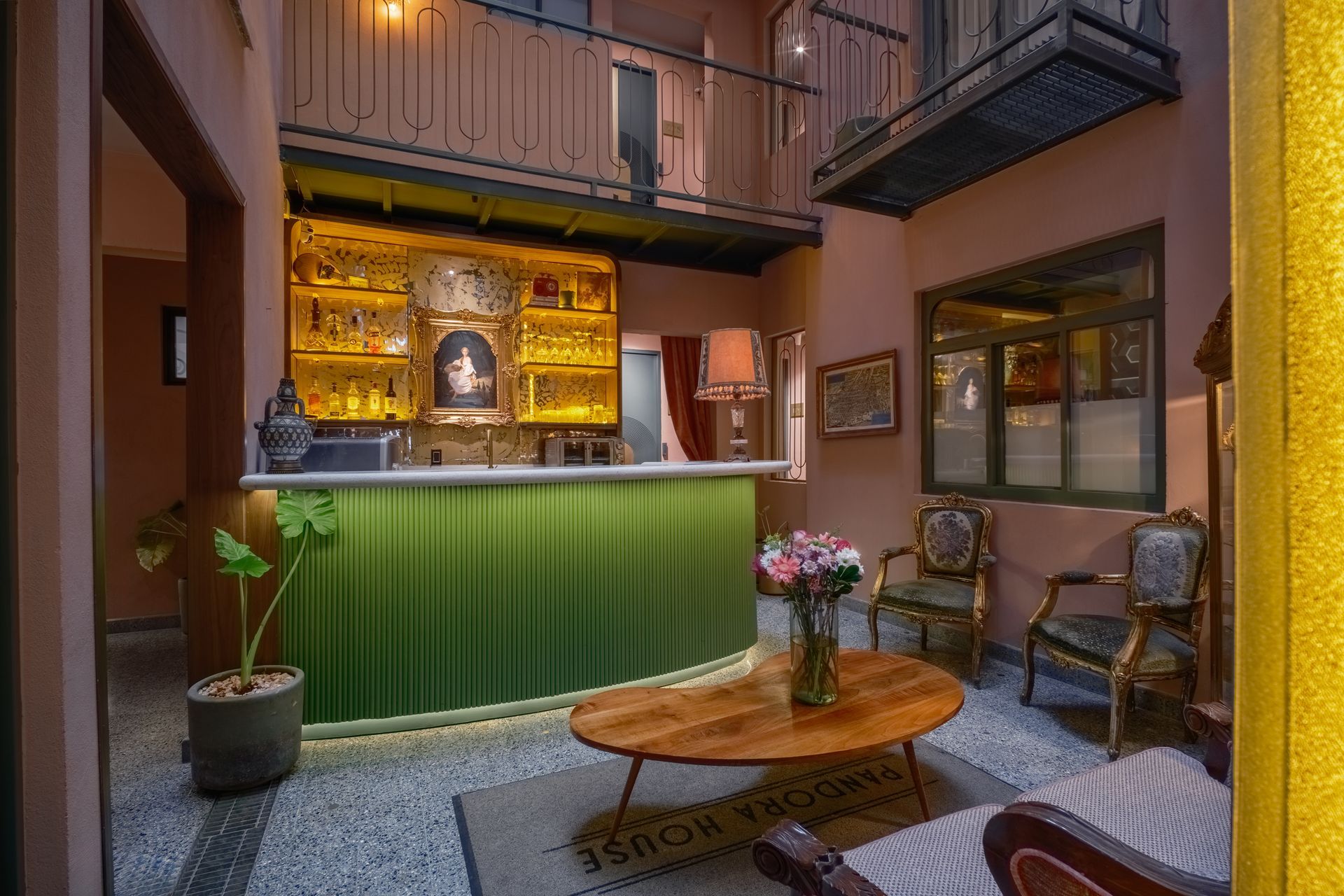 A hotel room with a bed , chairs , and a kitchen.