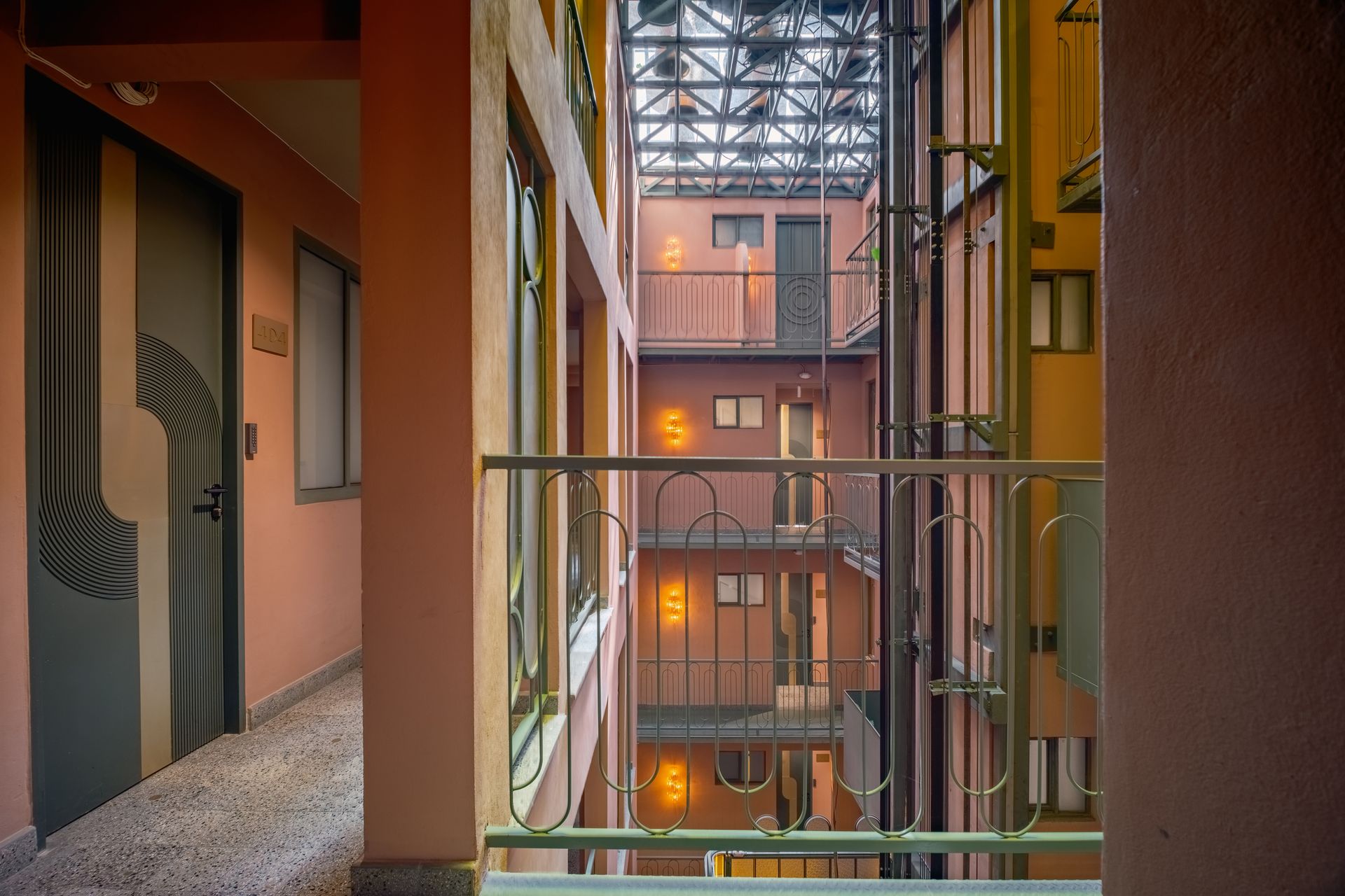 A hotel room with a bed , table , and mirror.