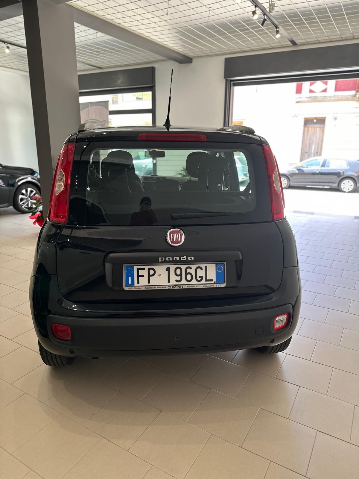 Una fiat panda nera è parcheggiata in un garage.