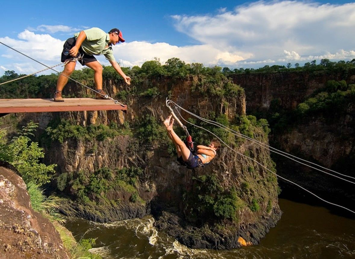 A man is standing on a bridge over a river