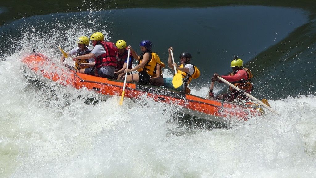 A group of people are rafting down a river