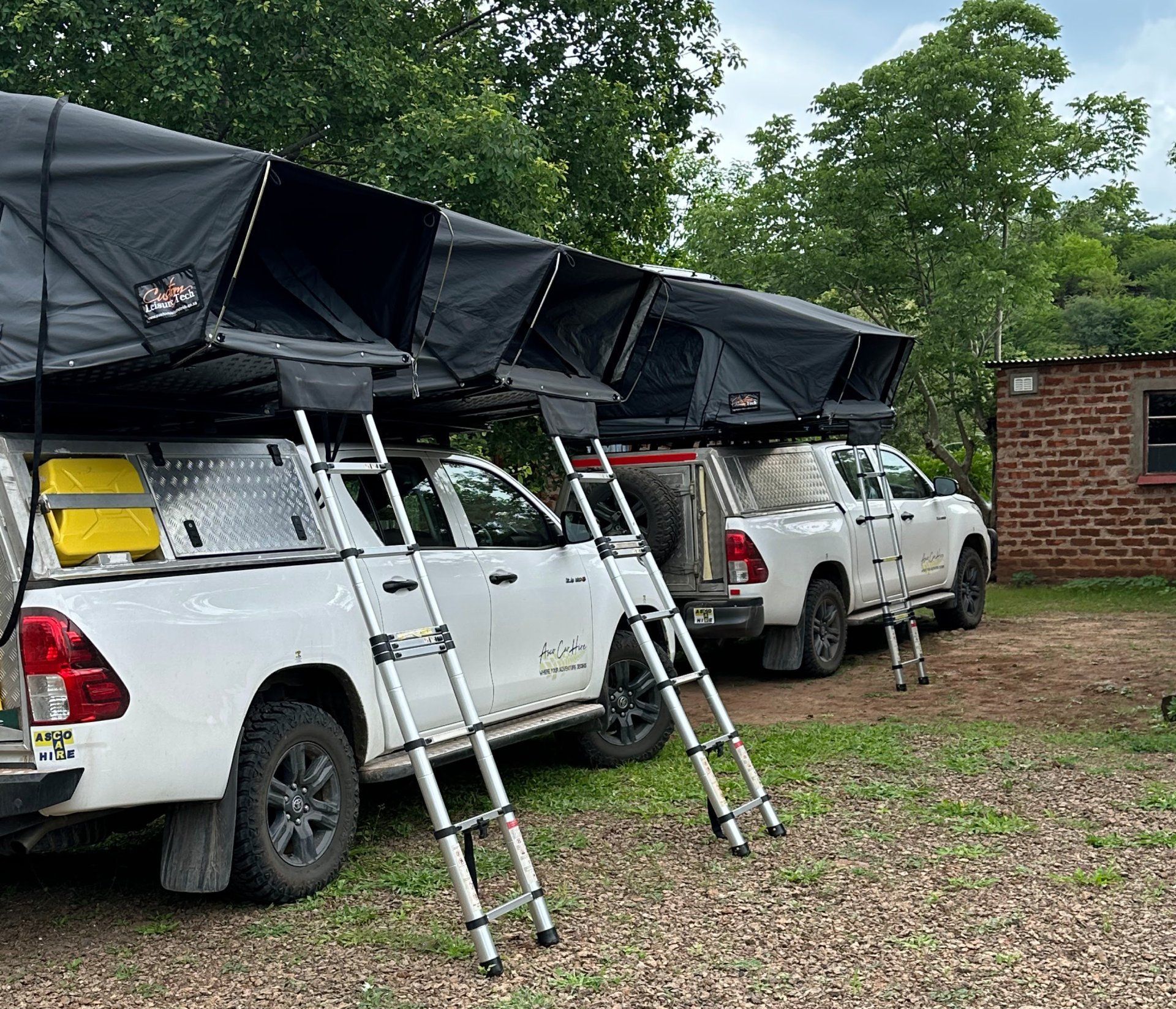 A group of people are sitting in chairs in front of a truck.