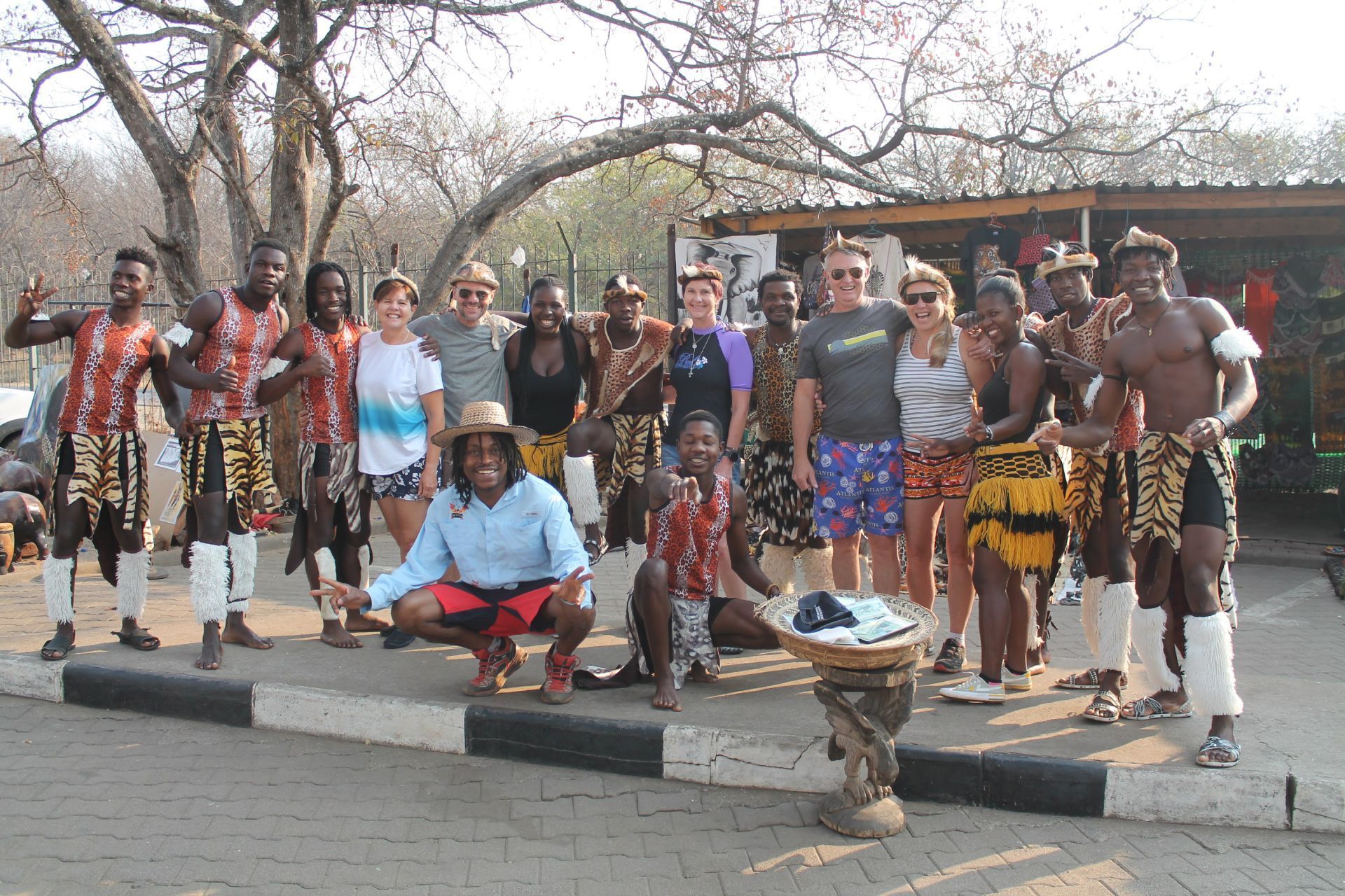 A group of people are posing for a picture on a sidewalk