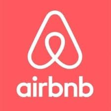 The airbnb logo is on a red background.
