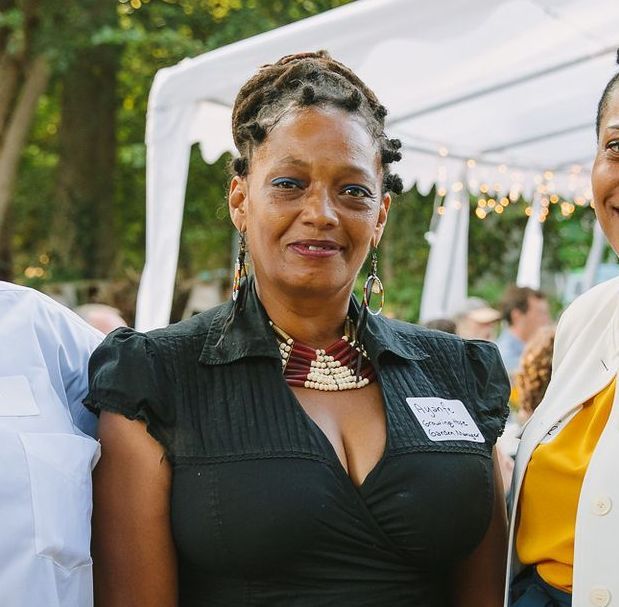 A woman wearing a black shirt with a name tag on it