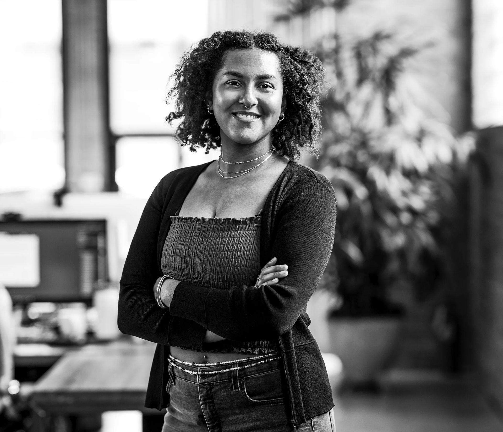 A woman is holding a megaphone and smiling for the camera