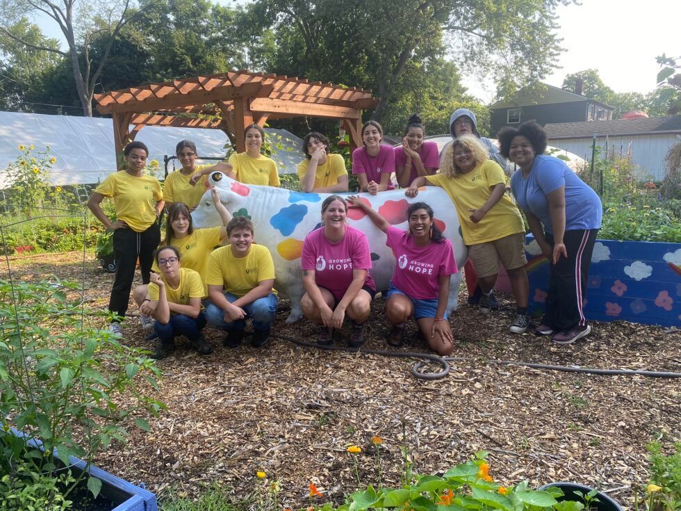 A group of people are posing for a picture in a garden.