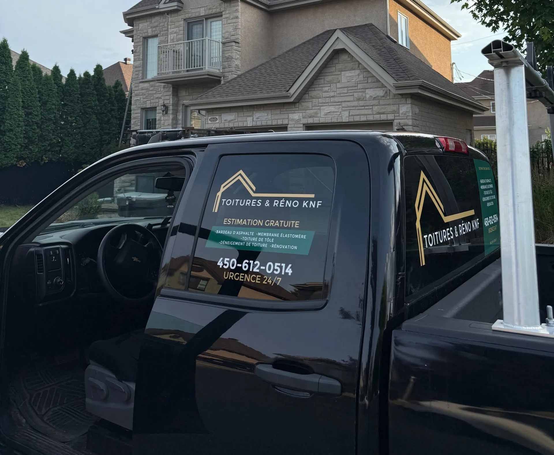 Camion noir avec logo garé près d'une maison ; le logo indique « Outsource Demo Pros » avec un numéro de téléphone.