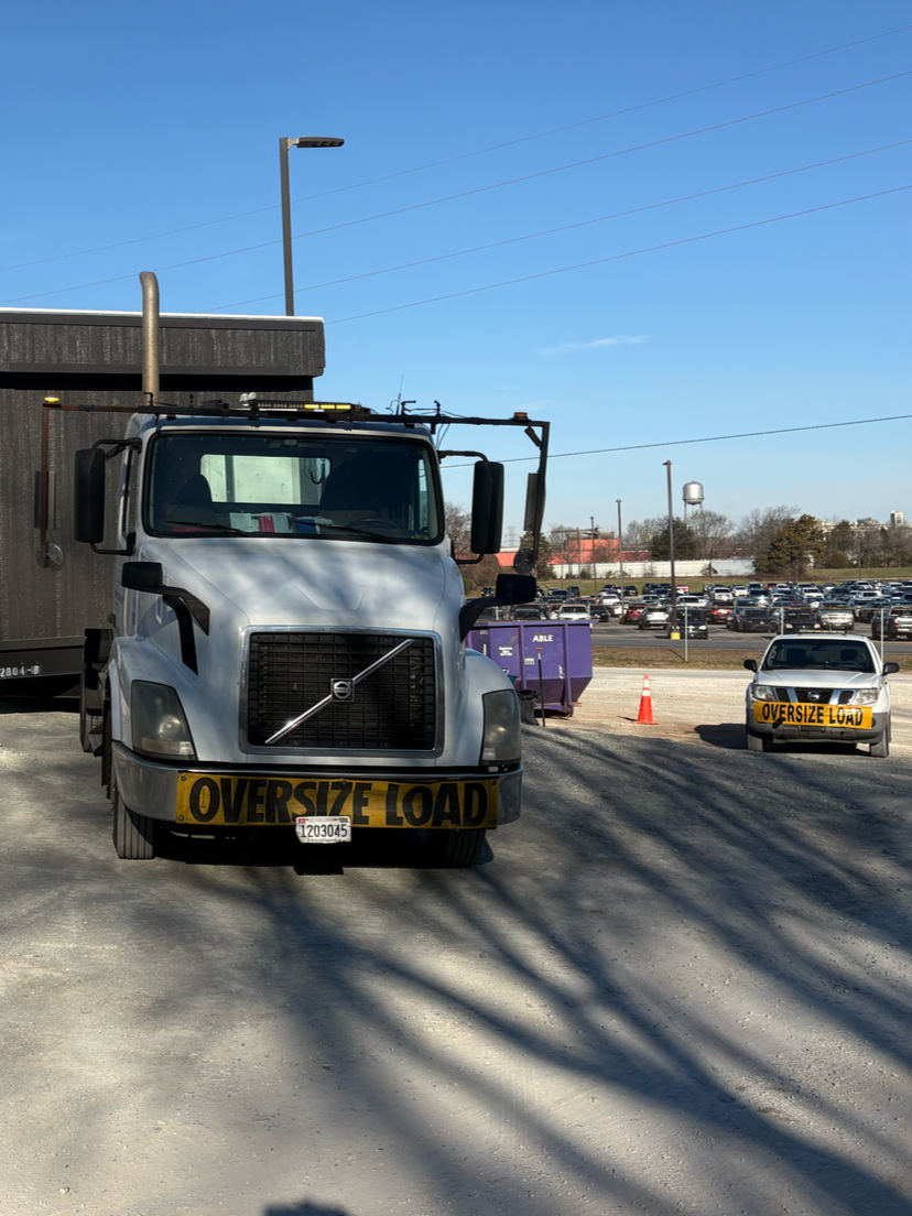 A white Volvo semi-truck labeled 