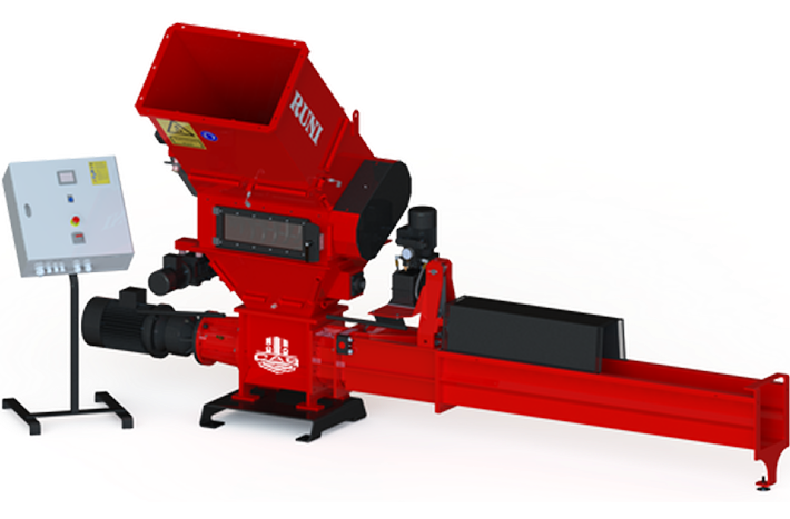 A red industrial plastic shredder with a hopper and a long horizontal discharge conveyor, accompanied by a control panel.