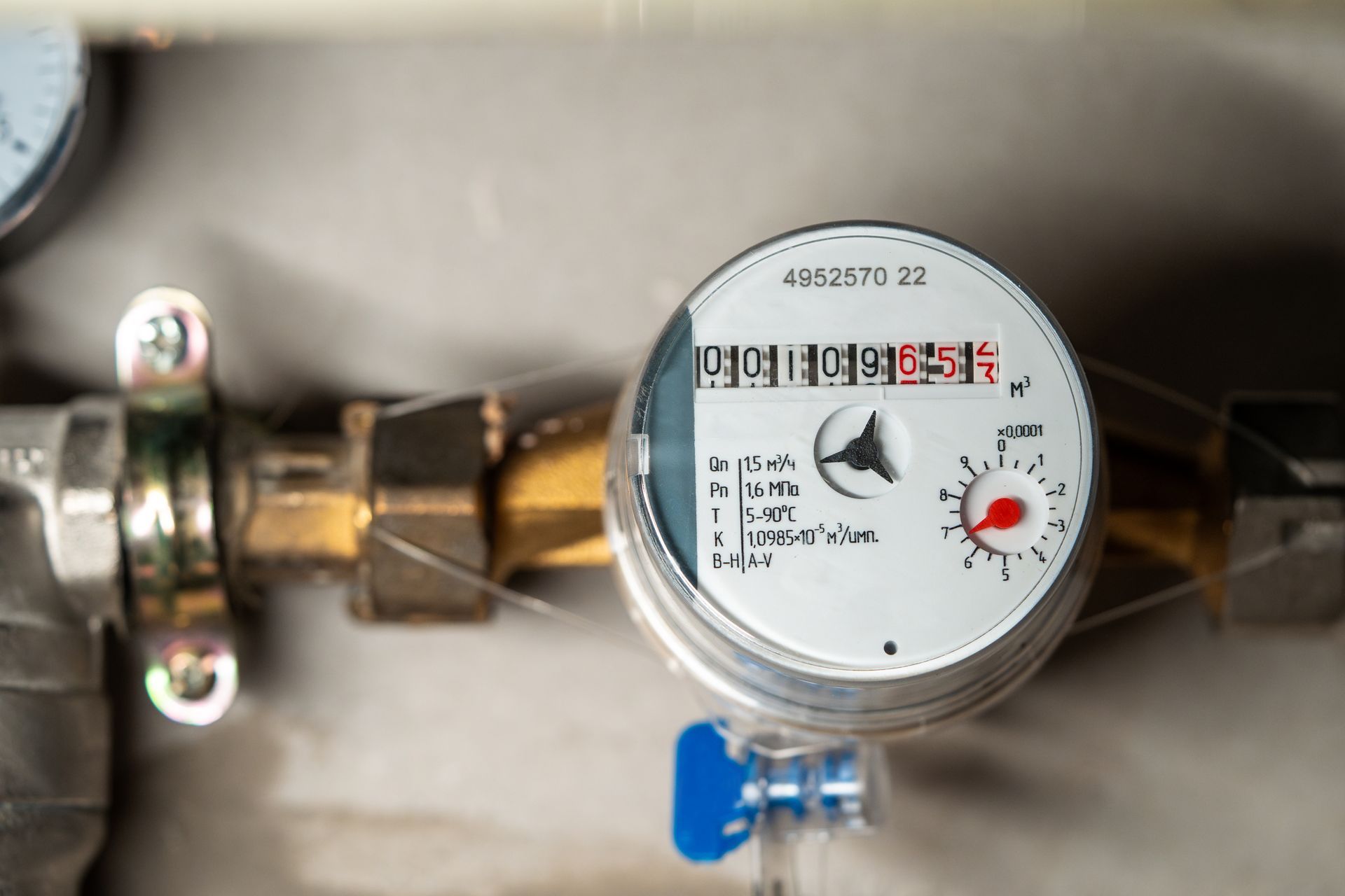 Gas meter with Korean label and brass pipe connections, shown close-up on a wall. Gas meter with Korean label and brass pipe connections, shown close-up on a wall.