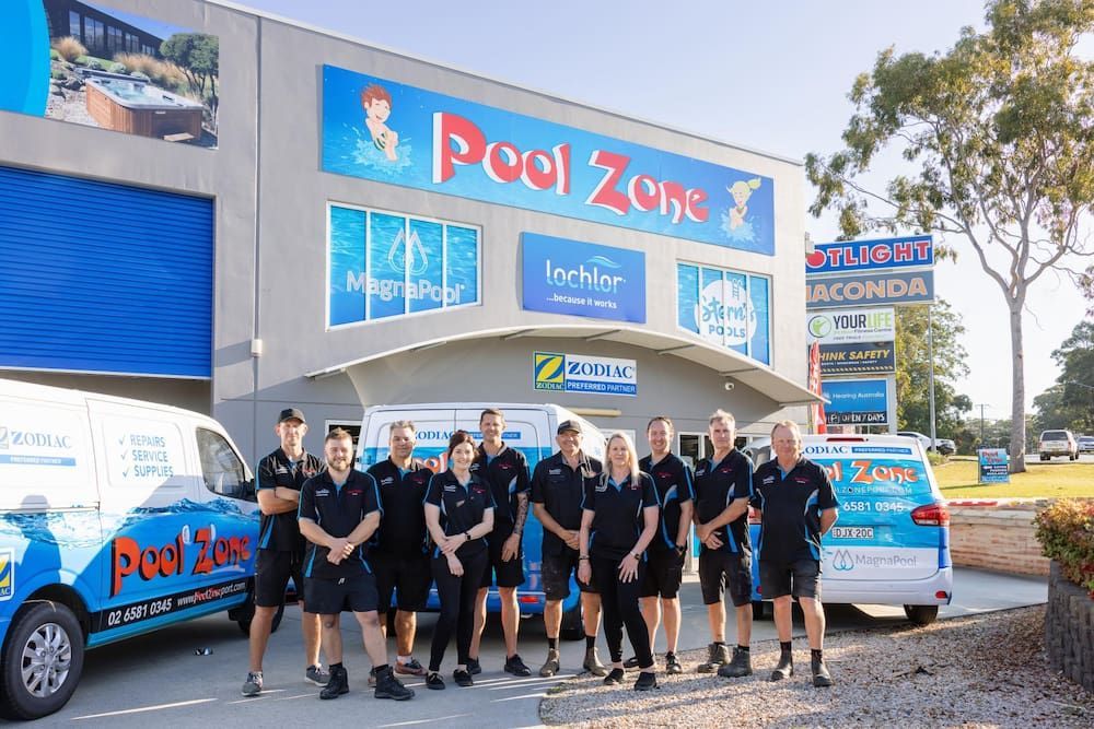 A Group of People Are Posing for a Picture in Front of a Building — Pool Zone in Port Macquarie, NSW