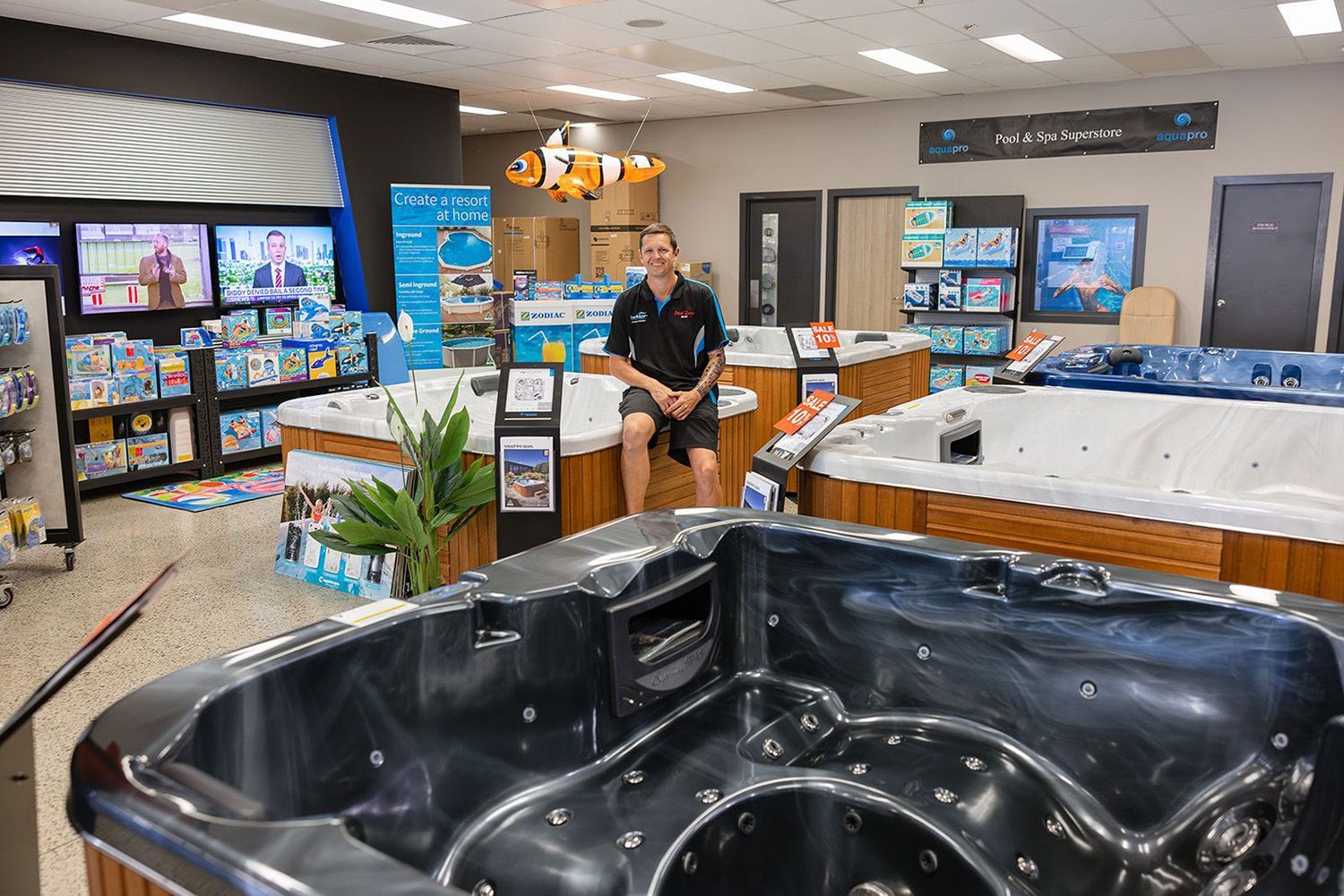 A White Pool Spa With A Wooden Base In A Store