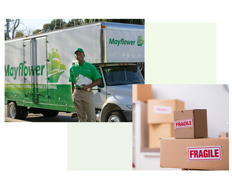 A man is standing in front of a moving truck and boxes.