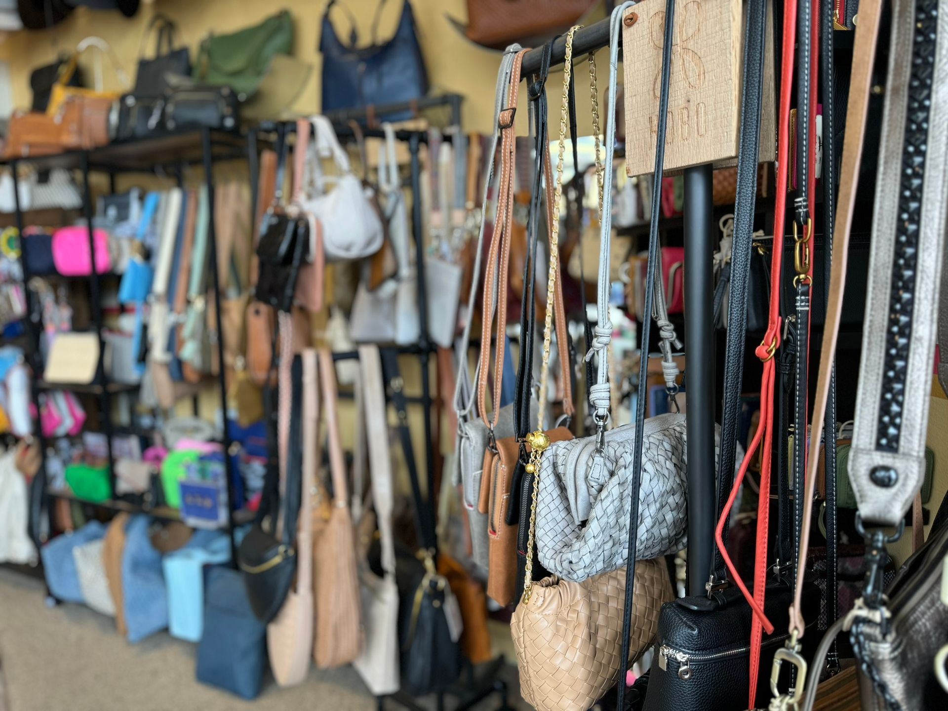 A store filled with lots of handbags and belts