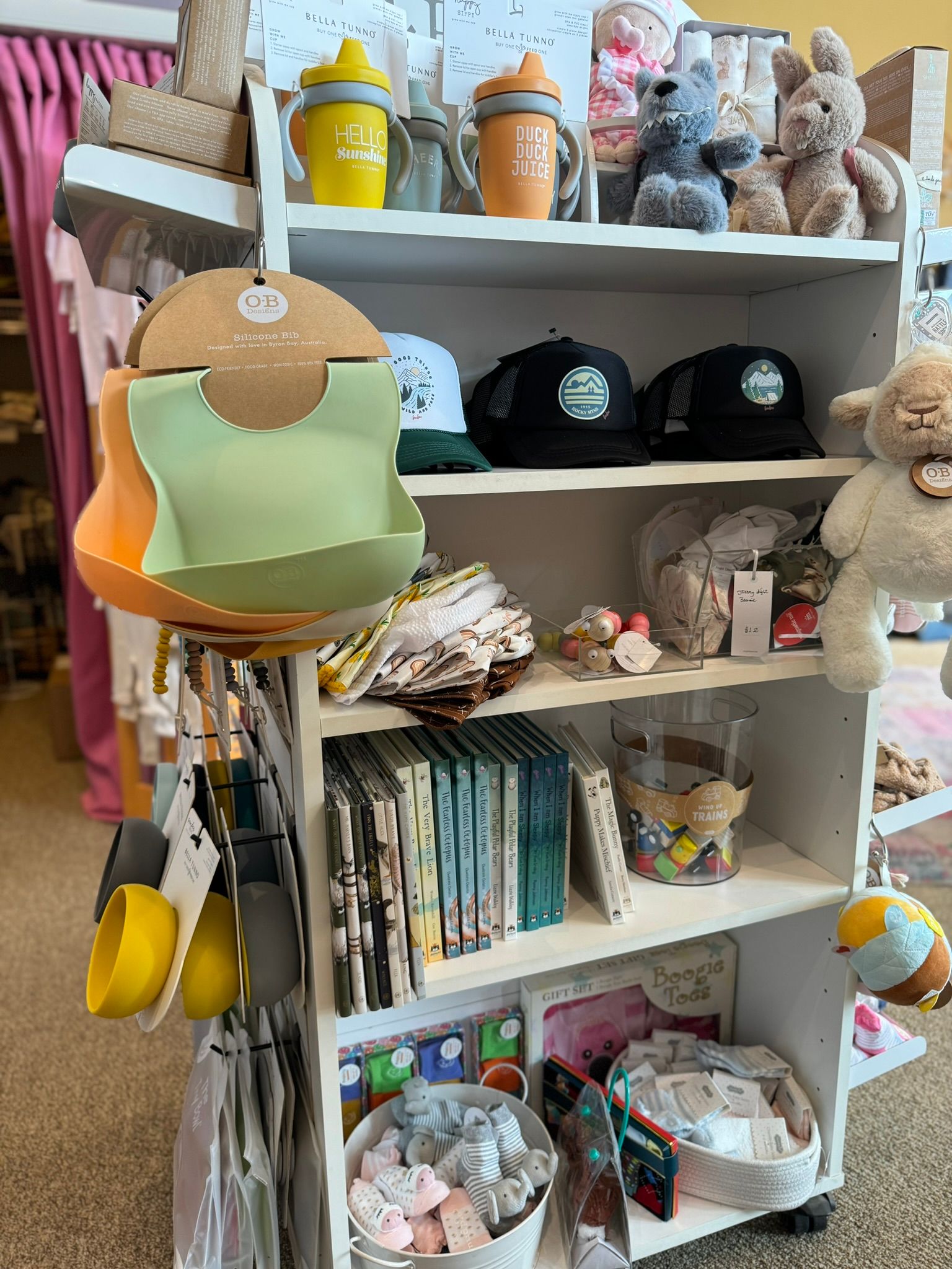 A shelf filled with lots of baby items in a store.