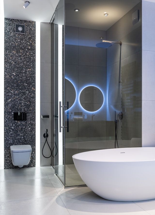 Backlit vanity mirror and a soaker tub located in the San Francisco Bay Area