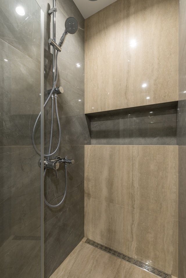 Big vertical tile installation in a shower for a bath renovation