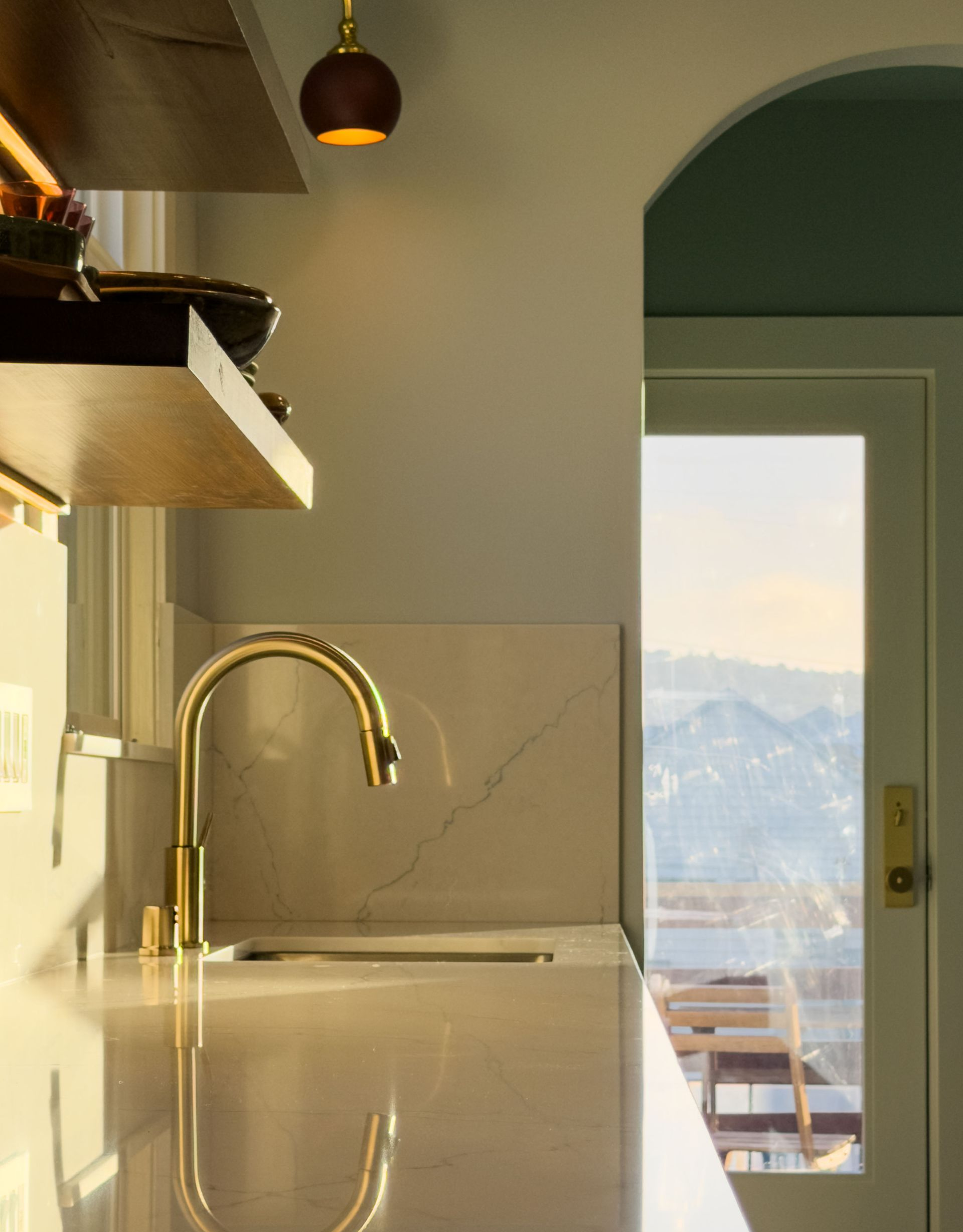 Modern bathroom with a toilet, built-in shelving, and neutral color scheme.