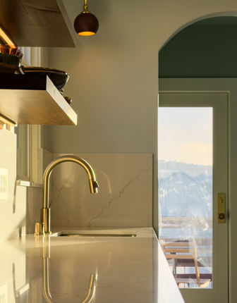 Modern bathroom with a toilet, built-in shelving, and neutral color scheme.