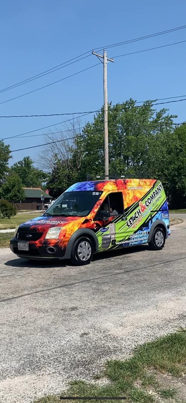 A colorful van is parked on the side of the road.