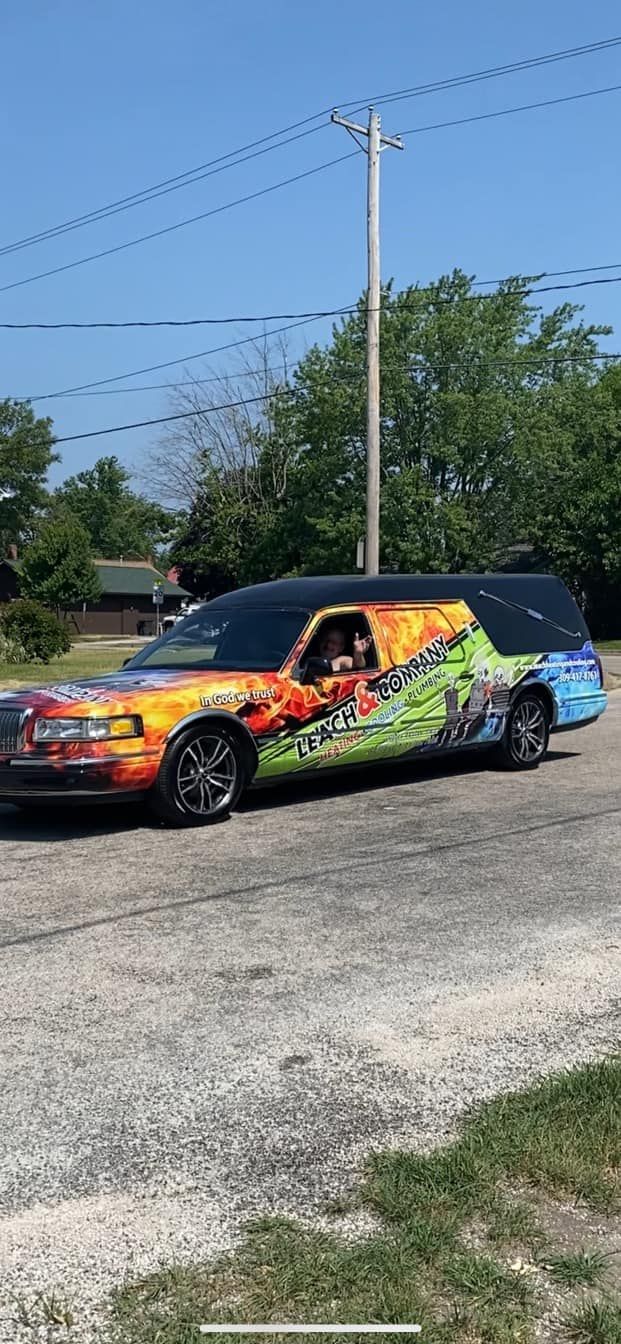 A colorful limousine is parked on the side of the road.