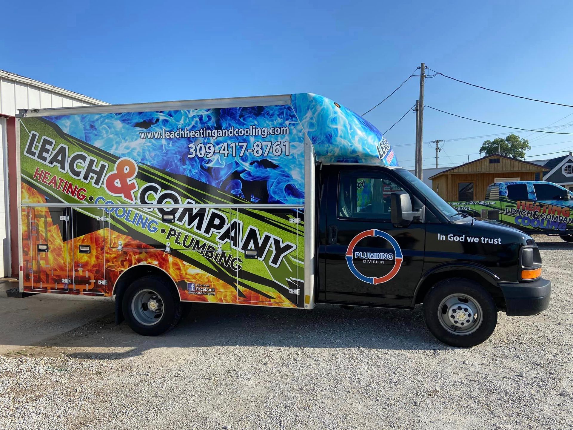 A bleach and company truck is parked in a gravel lot.
